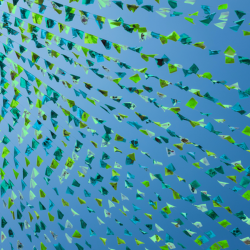 Decorative image showing green bunting against a blue sky