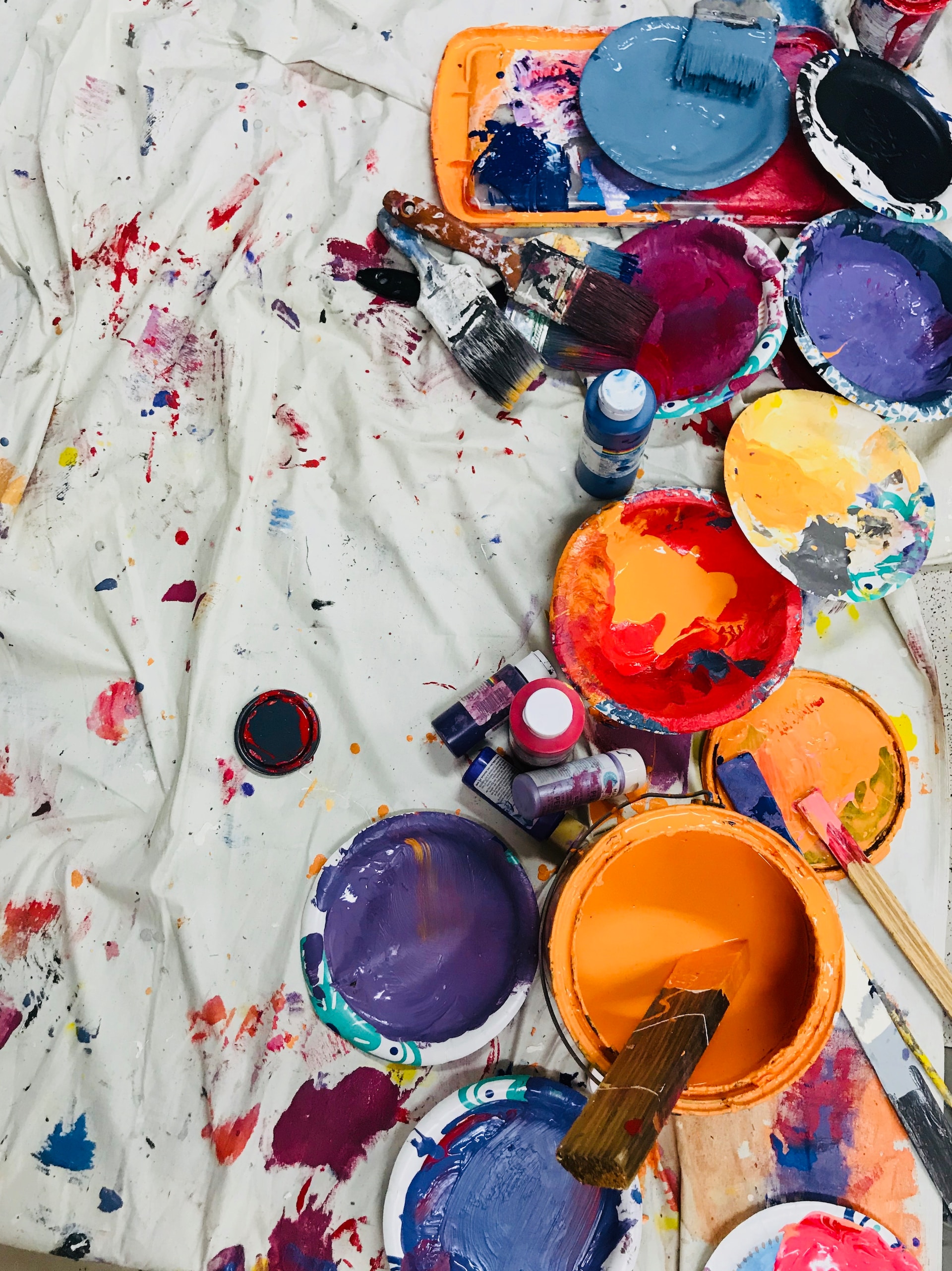 Paint cans, brushes and splattered paint CREDIT Taelynn Christopher via Unsplash